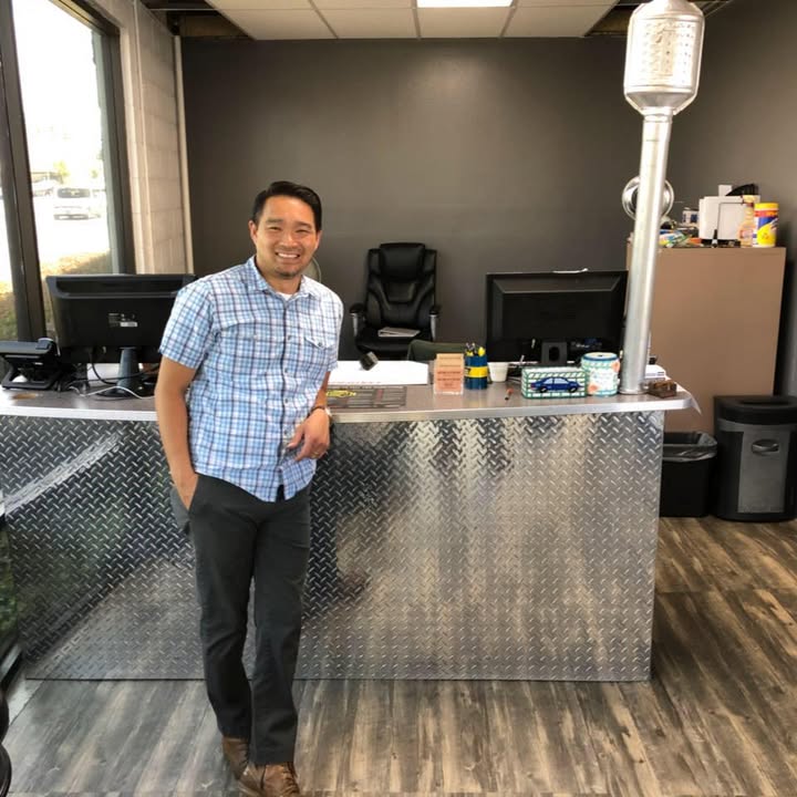 Sang, owner of Our King Auto Repair, at the front counter
